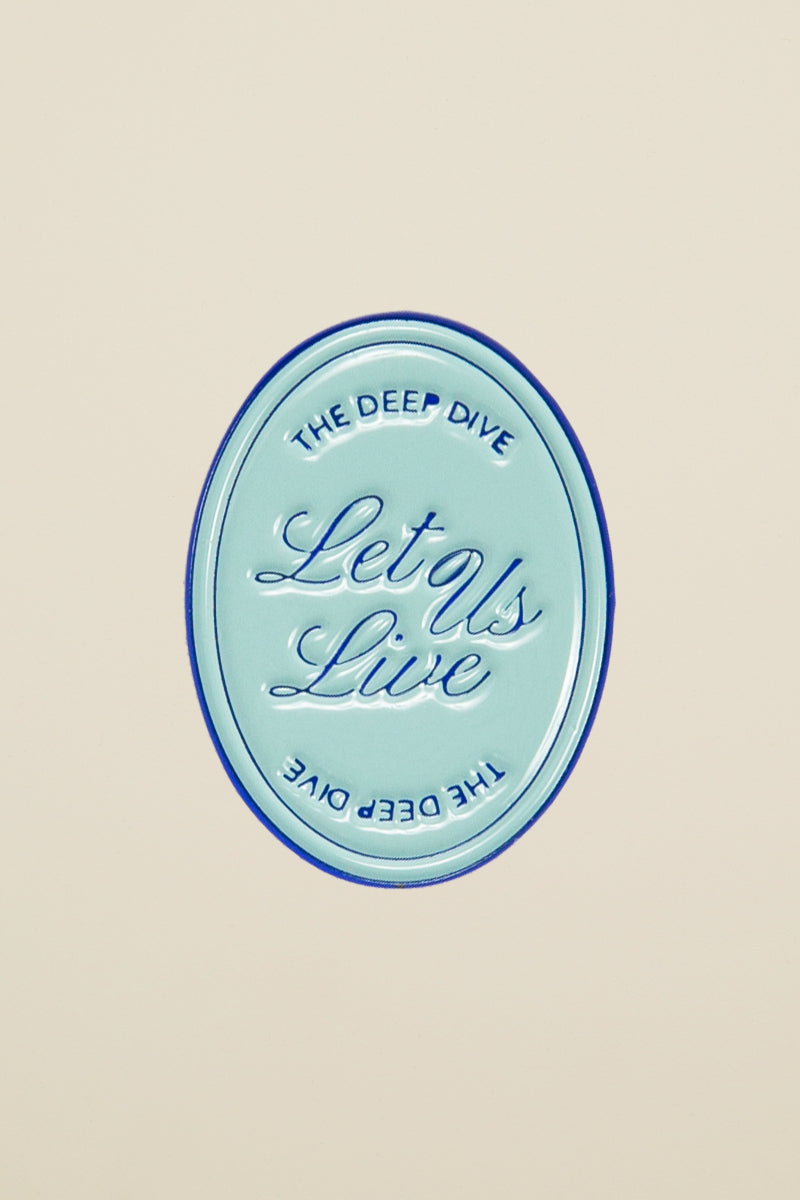 Let Us Live enamel pin from Kin Ship Goods – The Deep Dive podcast-inspired design. Perfect for fans, jackets, and tote bags.