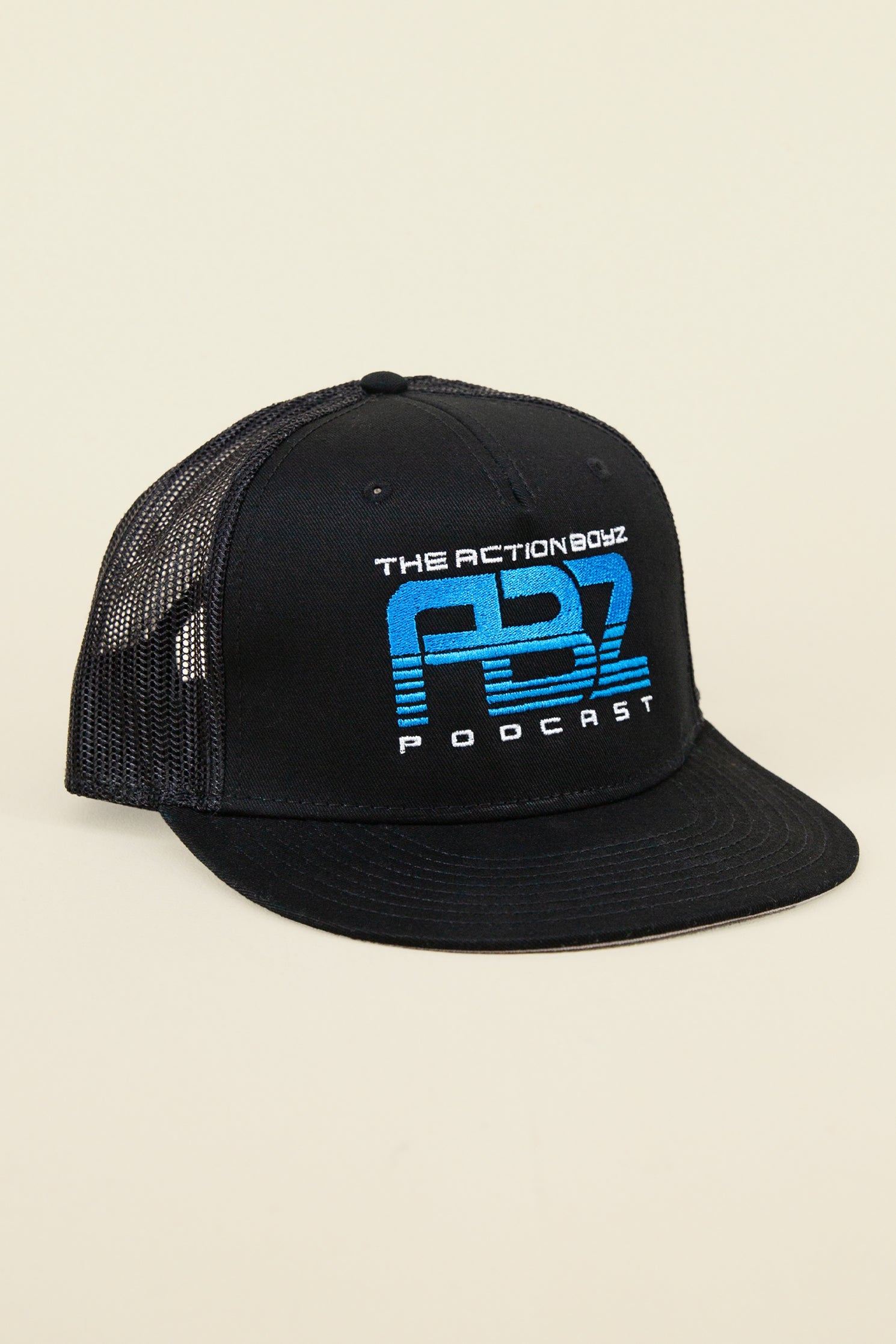 Kin Ship Goods black mesh trucker hat with blue Action Boyz Podcast logo—official podcast merchandise.