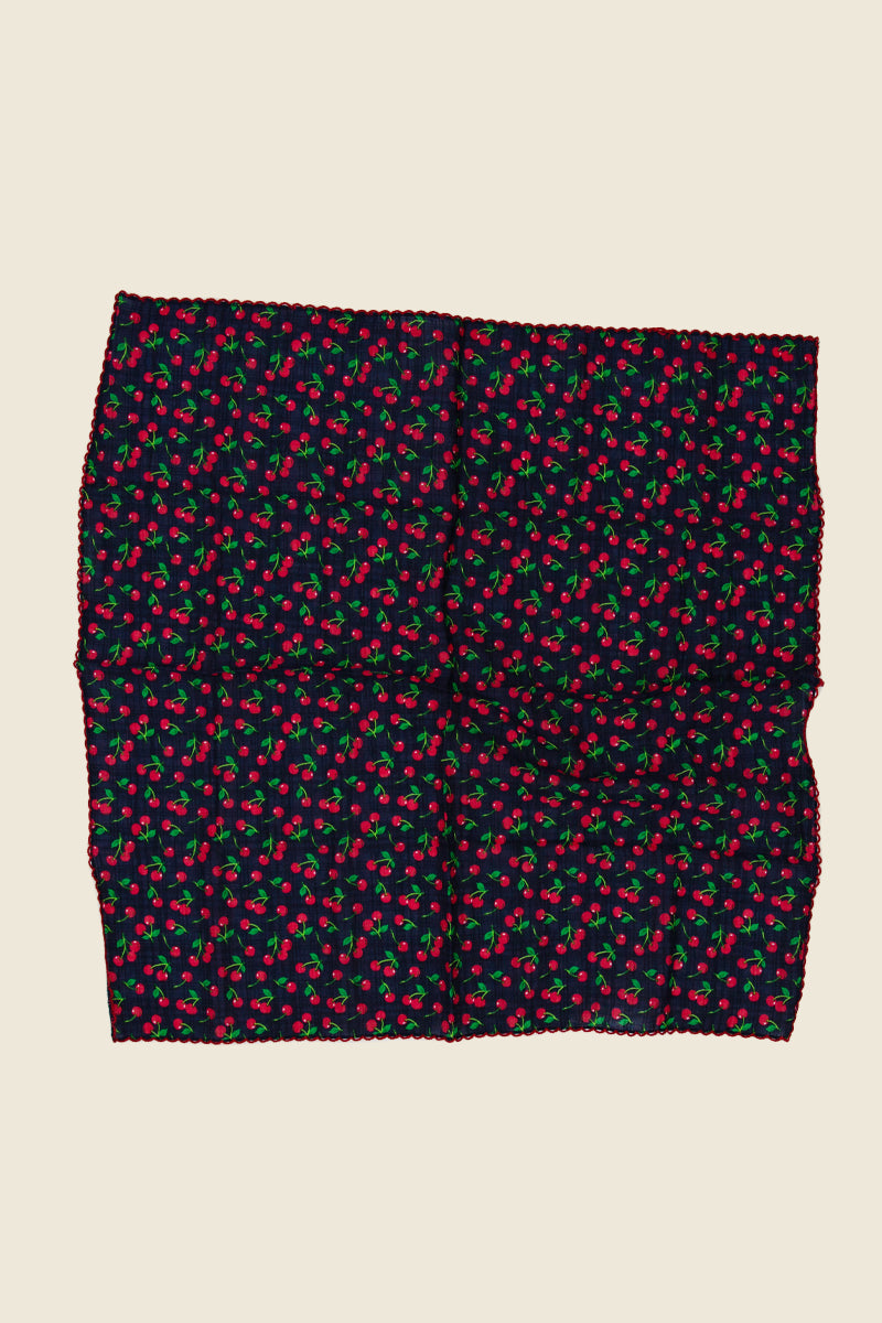 Kin Ship Goods cherry print bandana with tiny red cherries on navy—100% cotton and perfect for hair, neck, or pet wear.