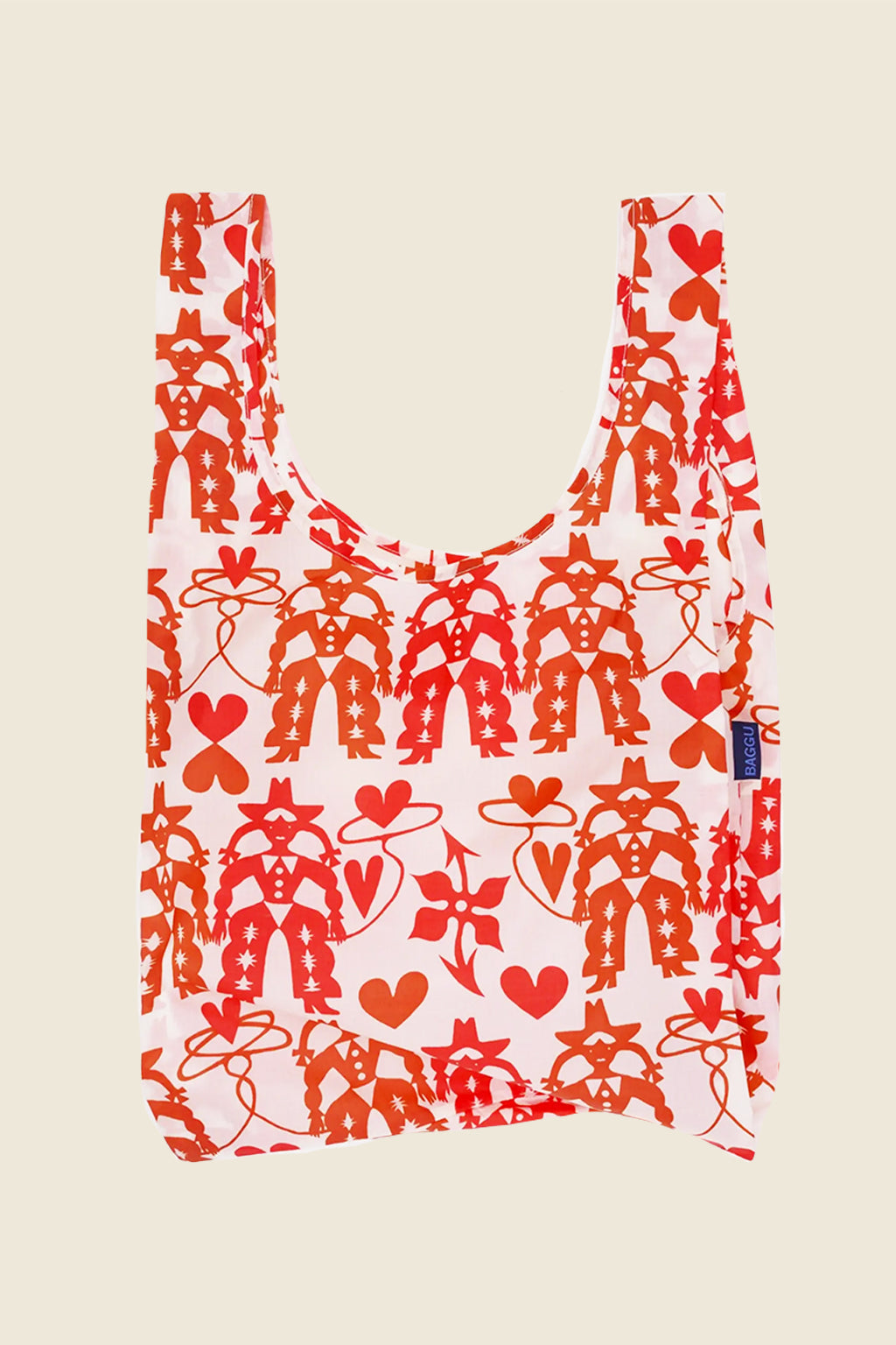 Cowgirl print Baggu reusable bag with red and orange western cowgirls, lassos, and hearts on a pale pink background