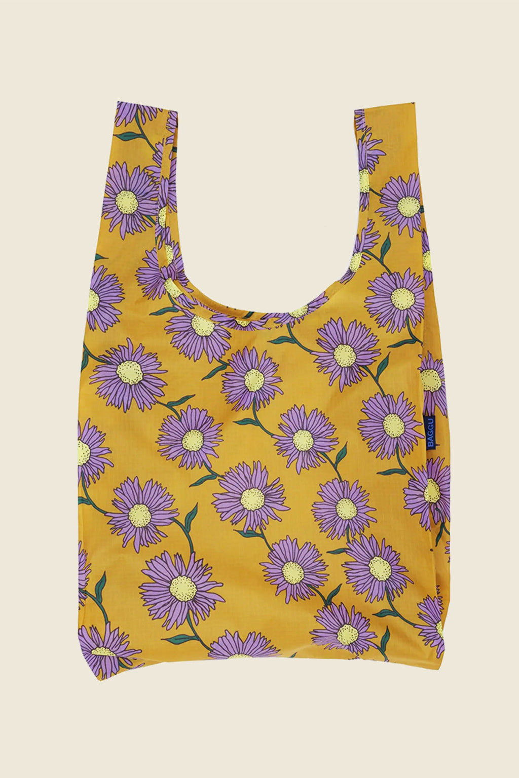 Kin Ship Goods Daisy Chain Baggu with bold purple flowers on golden yellow background