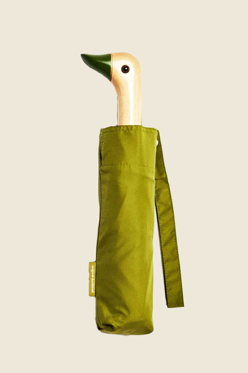 Kin Ship Goods olive green umbrella with carved wooden duck handle—compact, stylish umbrella with personality for rainy day protection.