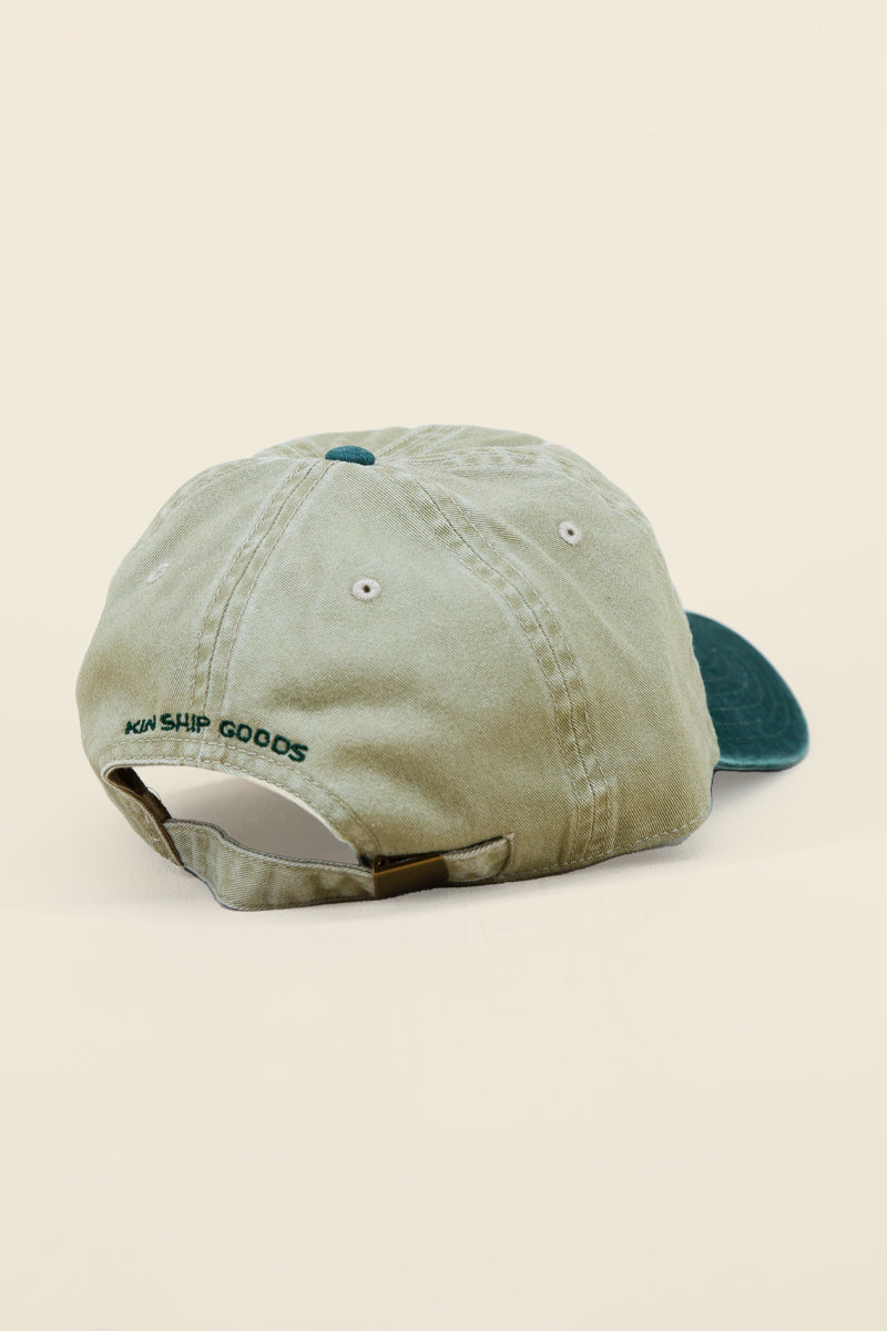 Kin Ship Goods Friends of Coleslaw dad hat with green embroidered logo—khaki and forest green cotton cap with Appalachian flair.