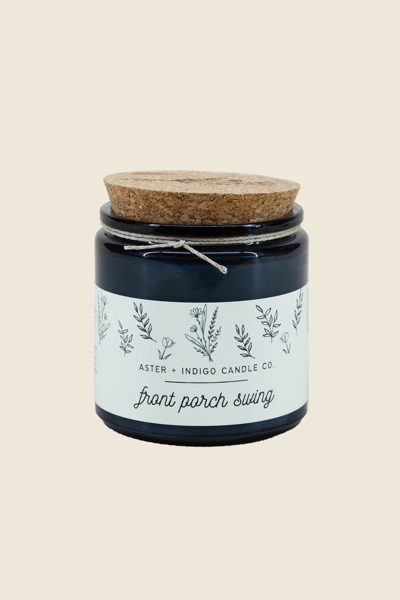 Kin Ship Goods Front Porch Swing candle with cork lid, featuring citrus, coconut, and vanilla notes in a soy blend.