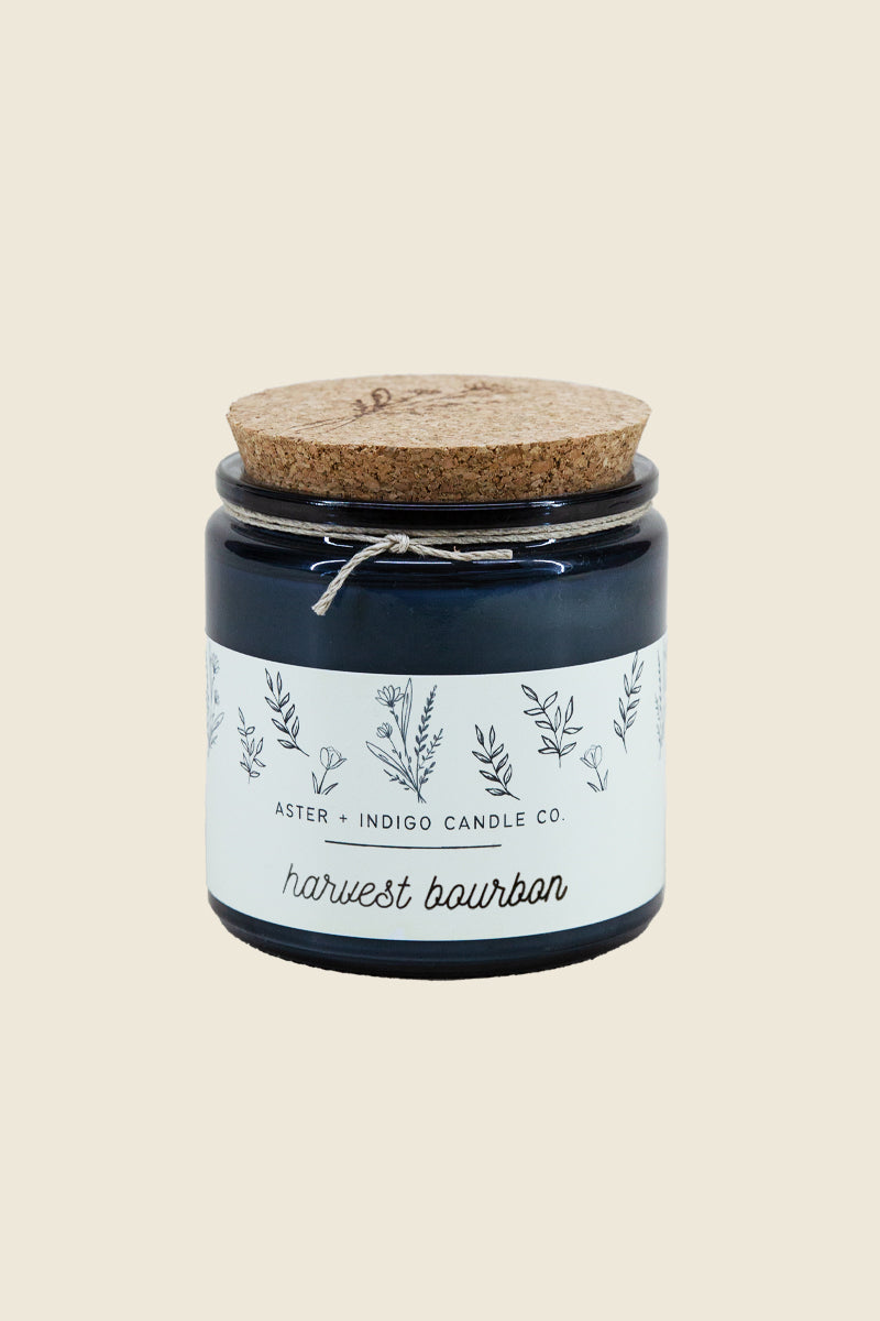 Kin Ship Goods Harvest Bourbon Candle by Aster + Indigo in blue glass jar with cork lid