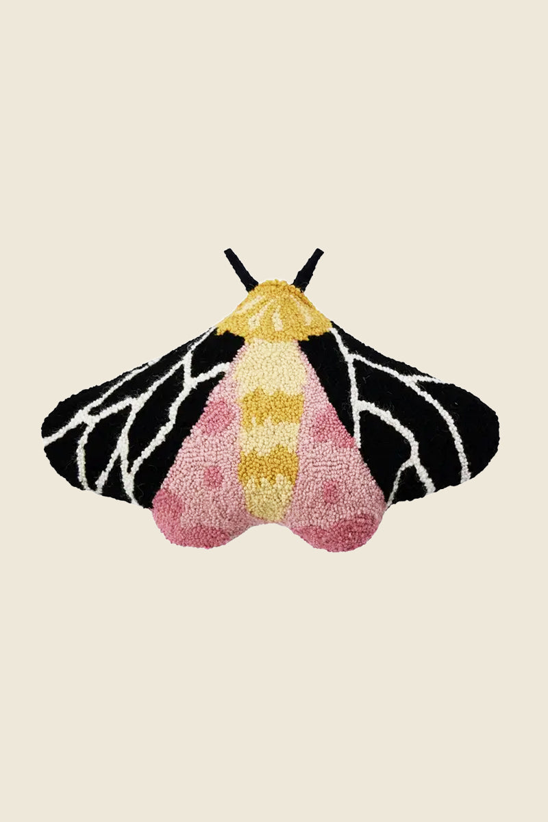 Kin Ship Goods moth-shaped hook pillow with black, pink, and gold wings—bold cottagecore accent for cozy, eclectic home decor.