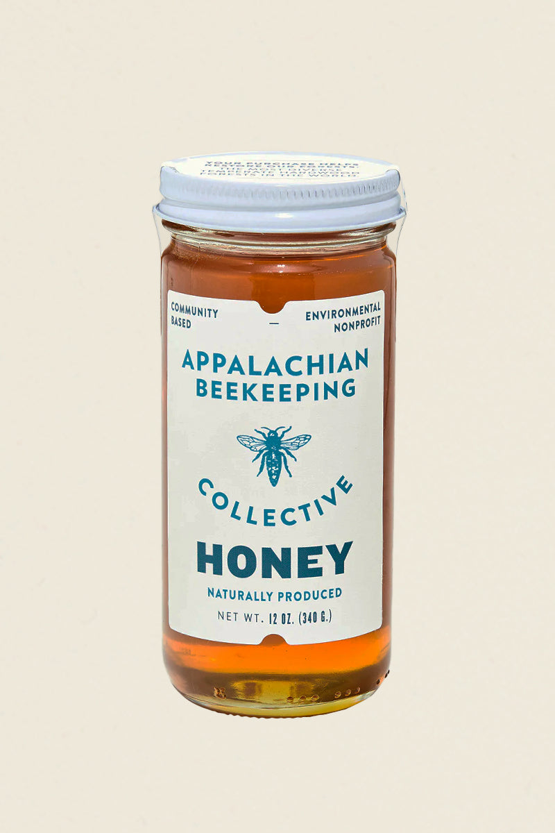 appalachian wildflower honey jar kin ship goods bee collective blue and white label on clear jar