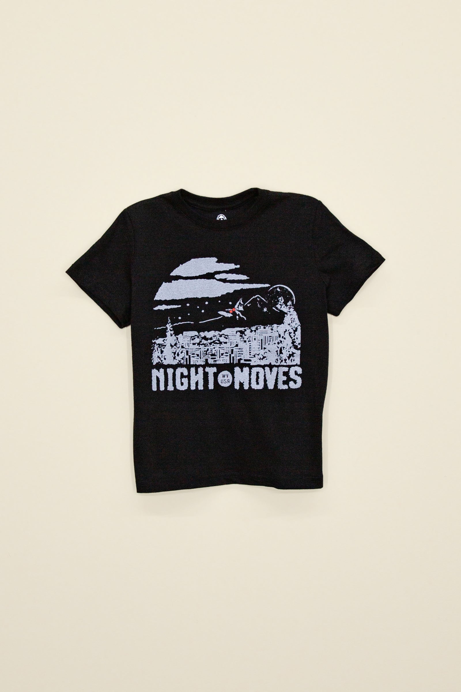 Kin Ship Goods black kids tee with ‘Night Moves USA’ moonlit cityscape and mothman silhouette graphic in white ink.