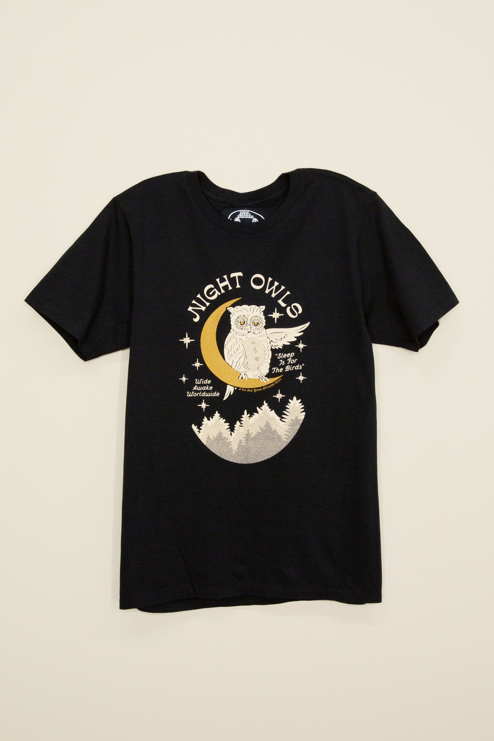 Kin Ship Goods black tee with owl on a crescent moon, forest below, and text reading 'Night Owls – Sleep Is for the Birds.'