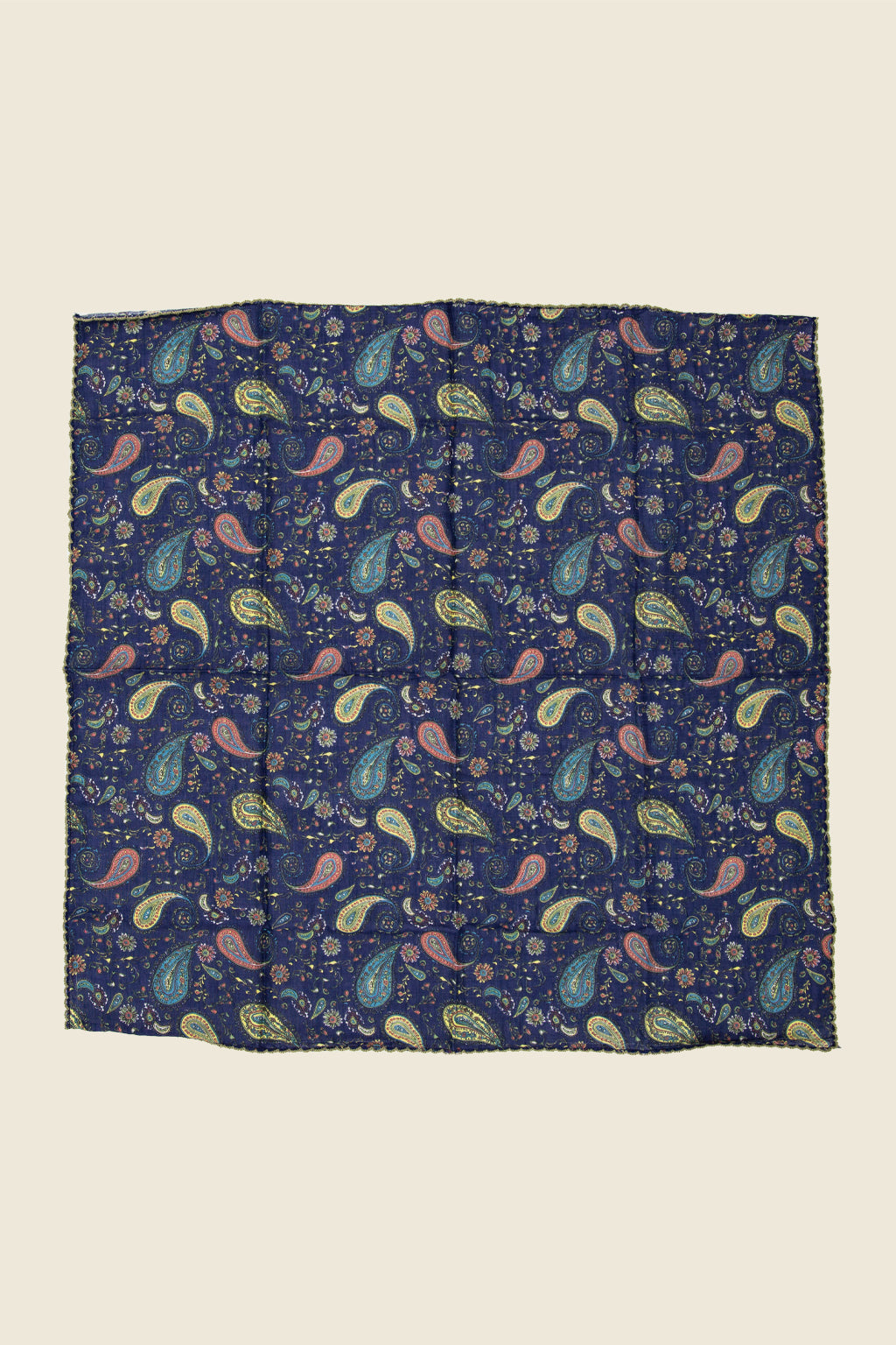 Navy blue bandana with colorful paisley pattern on a beige sold by Kin Ship Goods background