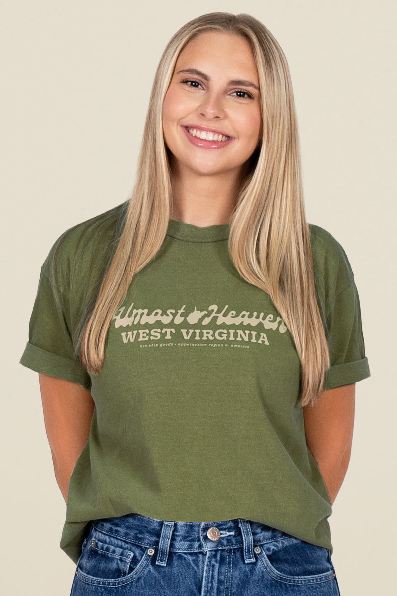 Kin Ship Goods olive green t-shirt with 'Almost Heaven West Virginia' text in vintage script across the chest.