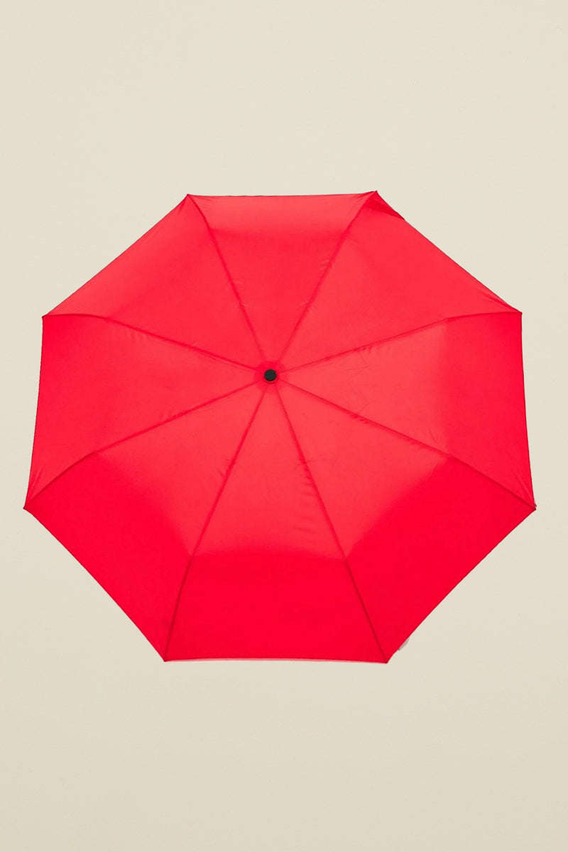 Kin Ship Goods compact red umbrella with wooden duck head handle and red beak—fun and functional rainy day accessory with personality.