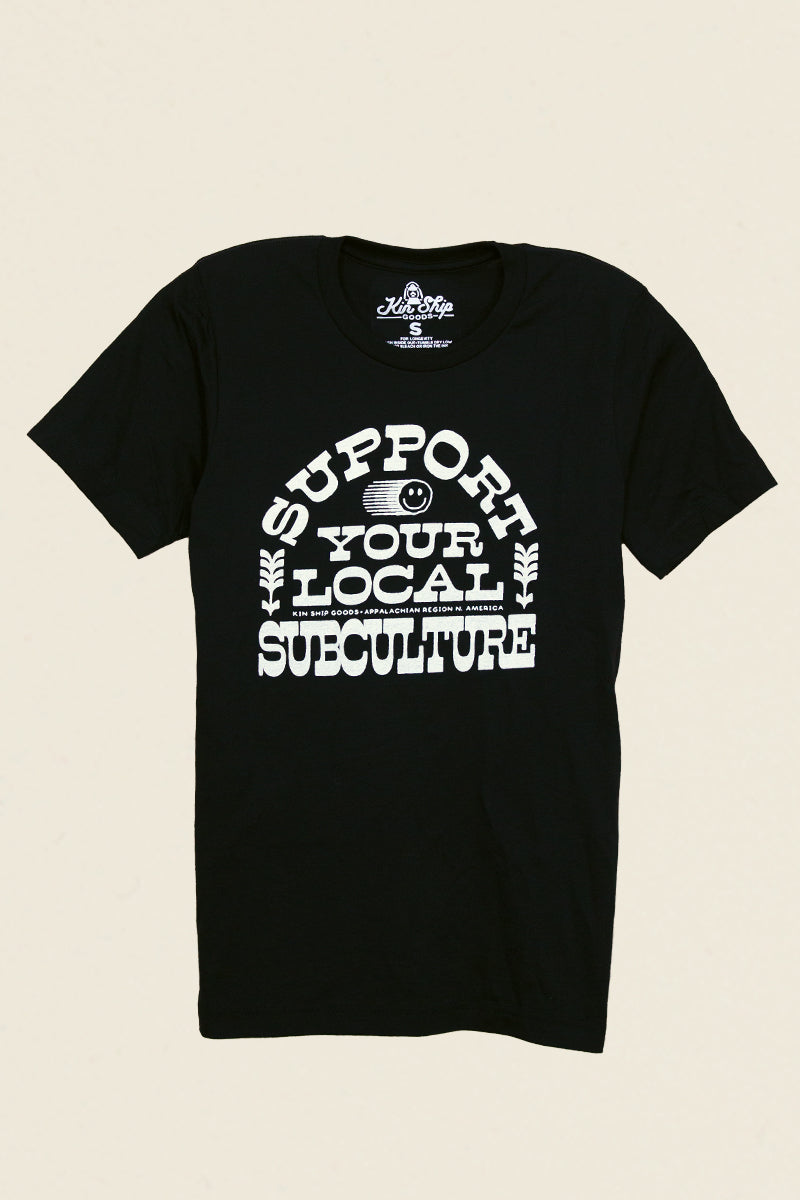 Kin Ship Goods black tee with bold white ‘Support Your Local Subculture’ text and smiley face graphic, Appalachian-made.