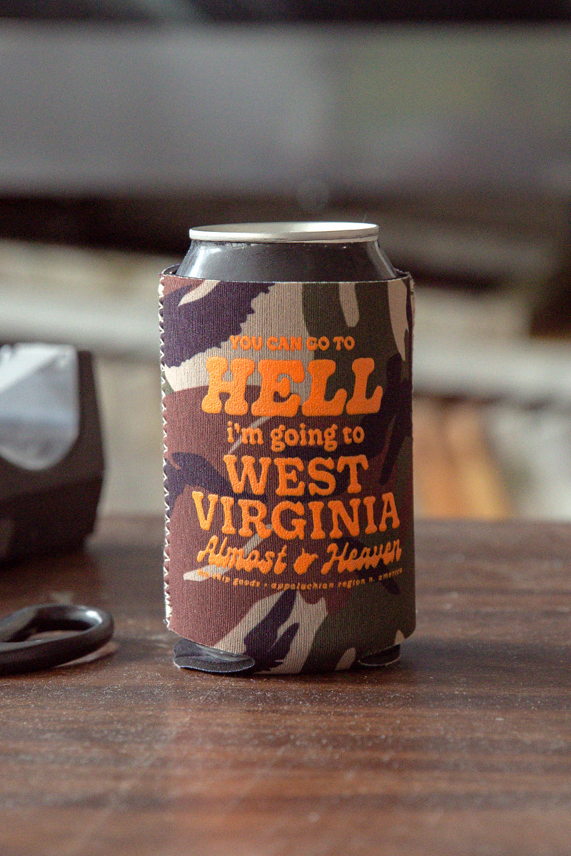 Kin Ship Goods camo koozie with “You can go to hell, I’m going to West Virginia” in orange print—Almost Heaven style drink holder.

